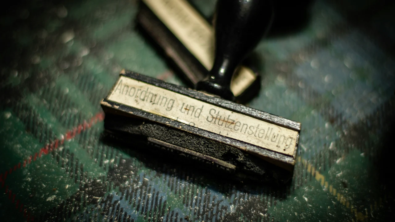 Rubber stamps on a worn surface, representing the appearance of formal approval without meaningful review