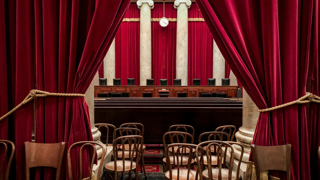 Courtroom interior with bench and curtains, representing formal structures of challenge and accountability