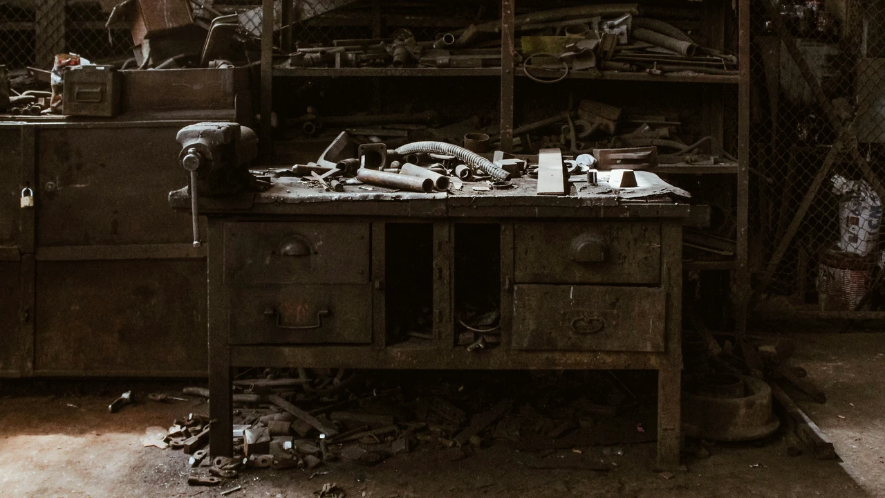 Abandoned workbench with scattered tools, representing skills and capability falling into disuse