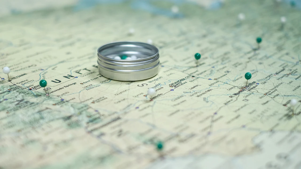 Map with pins and a compass, representing the practical work of mapping where AI already shapes decisions