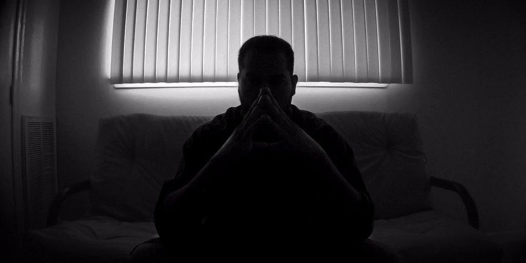 Silhouetted figure in contemplation, representing the deliberation behind AI trust decisions